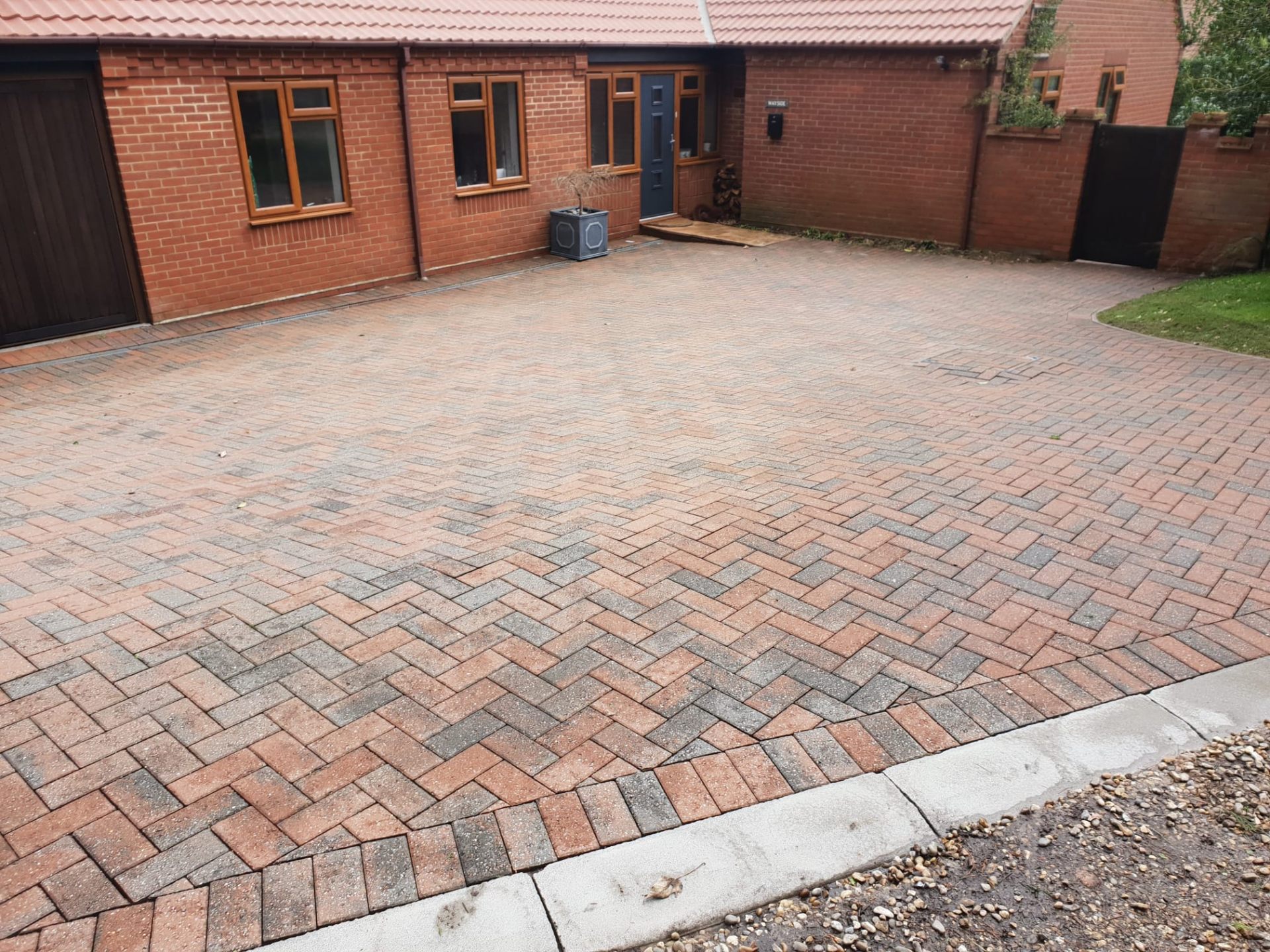 Freshly cleaned block paving driveway in herringbone pattern outside an Oxfordshire home